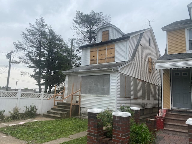 205-28 116th Rd, Saint Albans, NY 11412 - rear view of house featuring entry steps and fence