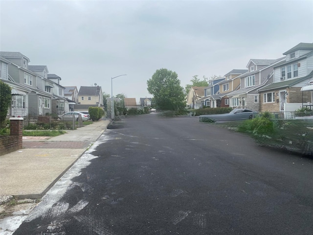 205-28 116th Rd, Saint Albans, NY 11412 - view of asphalt road with a residential view and street lights