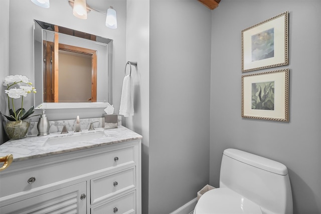 bathroom with toilet and vanity