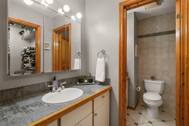 bathroom featuring tile patterned floors, toilet, and vanity
