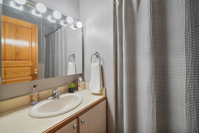 full bath with vanity and a shower with shower curtain