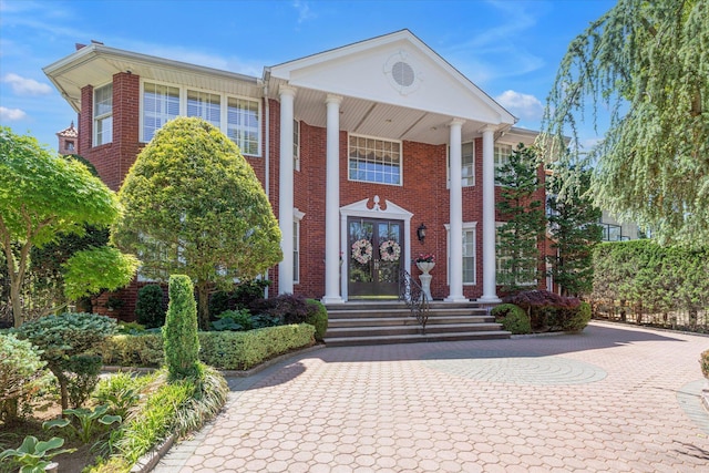 4 Point Cres, Malba, NY 11357 - greek revival inspired property featuring french doors, brick siding, and decorative driveway