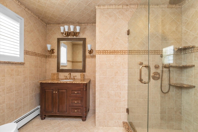 4 Point Cres, Malba, NY 11357 - bathroom featuring a baseboard radiator, plenty of natural light, a shower stall, vanity, and tile walls