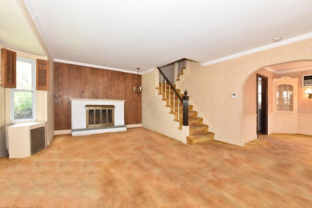 50 Fordham St, Williston Park, NY 11596 - unfurnished living room featuring radiator, arched walkways, stairway, ornamental molding, and a glass covered fireplace