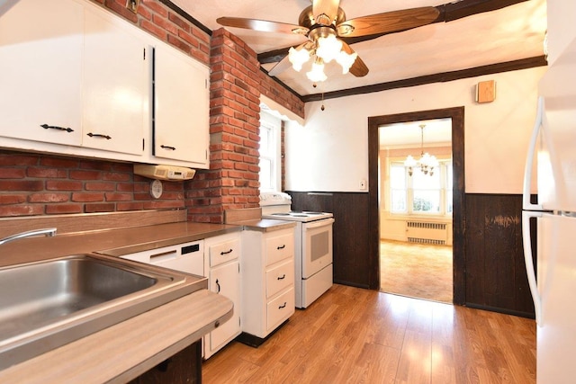 50 Fordham St, Williston Park, NY 11596 - kitchen featuring white appliances, radiator heating unit, a sink, wainscoting, and white cabinets
