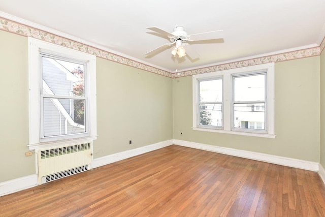 50 Fordham St, Williston Park, NY 11596 - spare room with radiator heating unit, baseboards, hardwood / wood-style floors, plenty of natural light, and crown molding