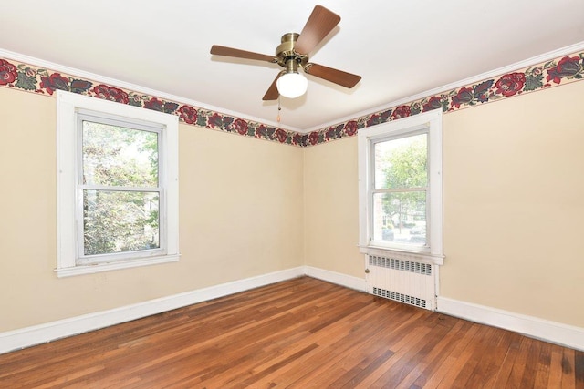 50 Fordham St, Williston Park, NY 11596 - spare room featuring radiator heating unit, hardwood / wood-style floors, baseboards, crown molding, and ceiling fan