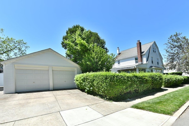 50 Fordham St, Williston Park, NY 11596 - view of home's exterior with an outbuilding and a detached garage