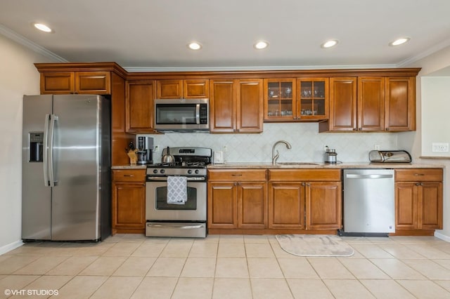 150 Arthur St, Massapequa Park, NY 11762 - kitchen with appliances with stainless steel finishes, a sink, crown molding, tasteful backsplash, and brown cabinets