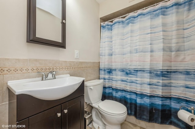 150 Arthur St, Massapequa Park, NY 11762 - bathroom featuring tile walls, vanity, toilet, wainscoting, and curtained shower