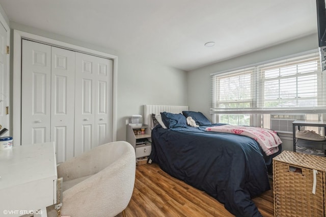 150 Arthur St, Massapequa Park, NY 11762 - bedroom with wood finished floors, a closet, and cooling unit