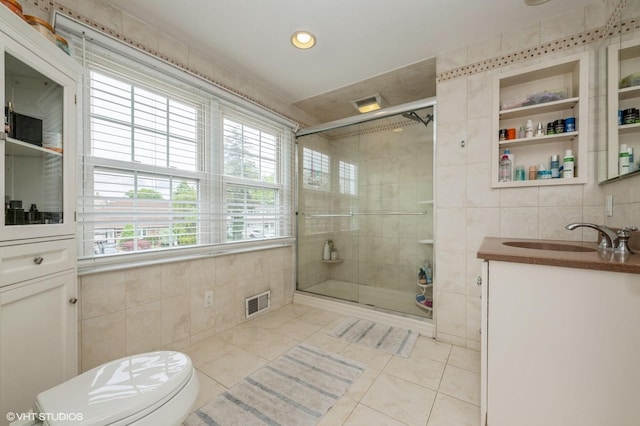 150 Arthur St, Massapequa Park, NY 11762 - full bath with tile walls, tile patterned flooring, vanity, toilet, and a stall shower