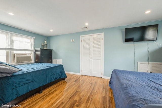 150 Arthur St, Massapequa Park, NY 11762 - bedroom with wood finished floors, baseboards, recessed lighting, cooling unit, and a closet