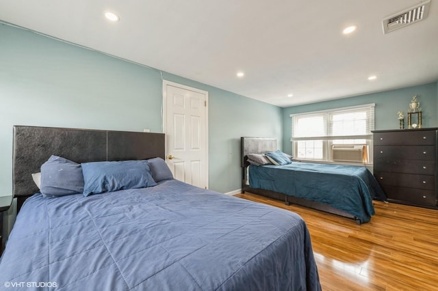 150 Arthur St, Massapequa Park, NY 11762 - bedroom featuring wood finished floors, recessed lighting, and cooling unit