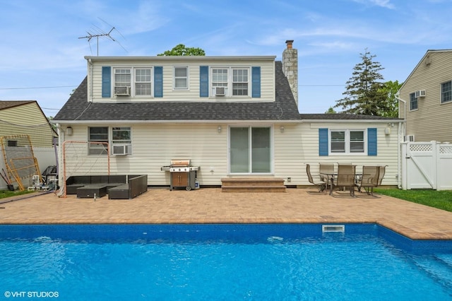 150 Arthur St, Massapequa Park, NY 11762 - rear view of house with entry steps, a patio, an outdoor living space, a gate, and a chimney