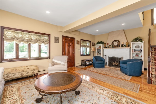 41-27 Orient Ave, Douglaston, NY 11363 - living area with wood finished floors, a fireplace, a baseboard radiator, and recessed lighting
