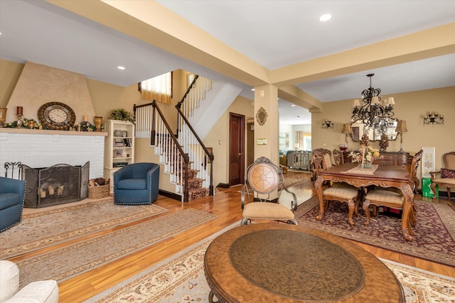 41-27 Orient Ave, Douglaston, NY 11363 - dining area featuring wood finished floors, stairway, a chandelier, a fireplace, and recessed lighting
