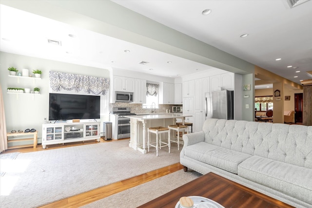 41-27 Orient Ave, Douglaston, NY 11363 - living room featuring light wood-style flooring, plenty of natural light, and recessed lighting