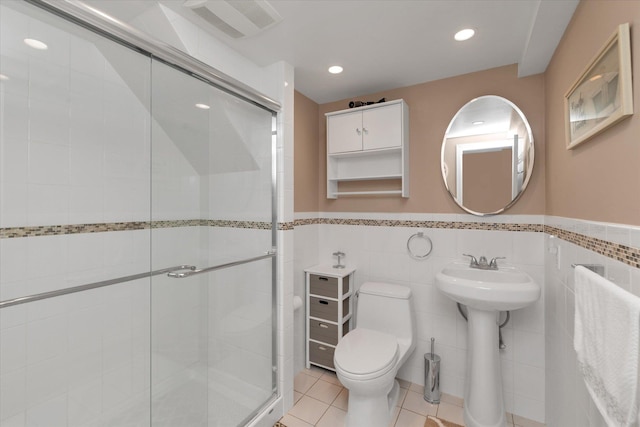 41-27 Orient Ave, Douglaston, NY 11363 - bathroom with toilet, a stall shower, wainscoting, tile walls, and tile patterned flooring