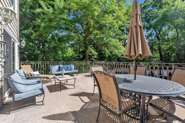 41-27 Orient Ave, Douglaston, NY 11363 - view of patio featuring an outdoor hangout area, view of wooded area, and outdoor dining space