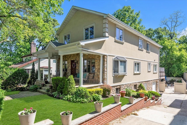 41-27 Orient Ave, Douglaston, NY 11363 - rear view of property with stone siding, stucco siding, driveway, a porch, and a yard