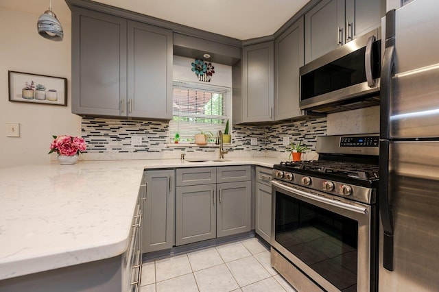 2588 Stedman Pl, Bronx, NY 10469 - kitchen featuring stainless steel appliances, gray cabinetry, a sink, backsplash, and light tile patterned floors