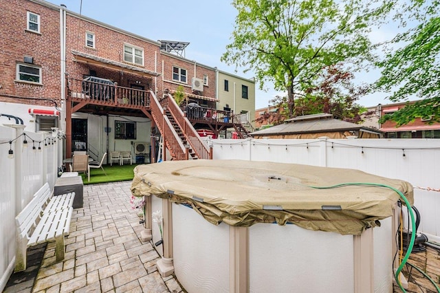 2588 Stedman Pl, Bronx, NY 10469 - back of house with a fenced backyard, stairway, a hot tub, a patio area, and a deck