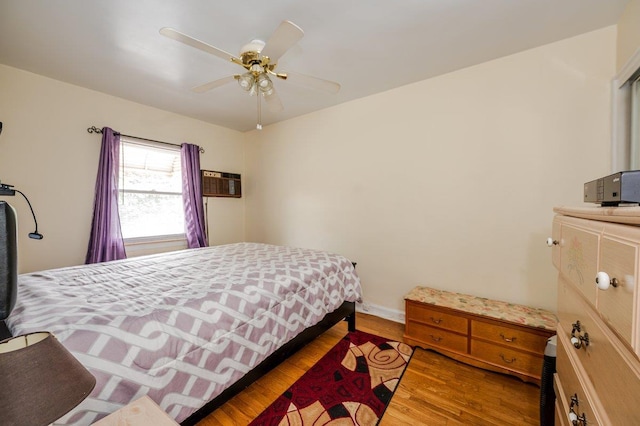 2588 Stedman Pl, Bronx, NY 10469 - bedroom featuring wood finished floors, a wall unit AC, a ceiling fan, and baseboards