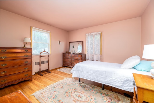 1427 Dartmouth St, Baldwin, NY 11510 - bedroom with radiator heating unit and light wood-type flooring