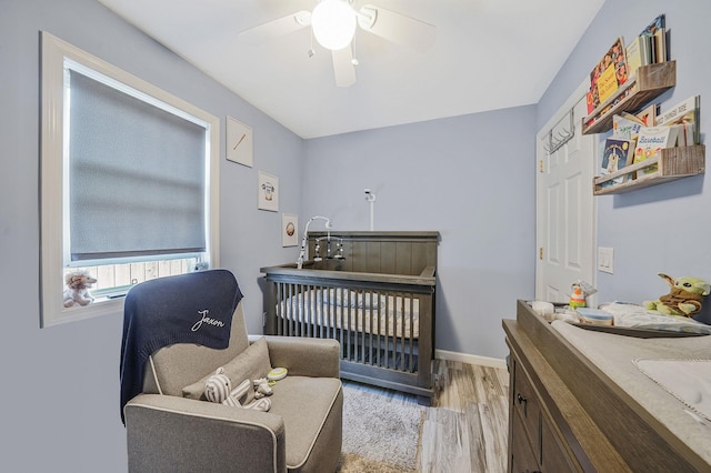1203 Cross Bay Blvd, Broad Channel, NY 11693 - bedroom with a nursery area, light wood finished floors, baseboards, and ceiling fan