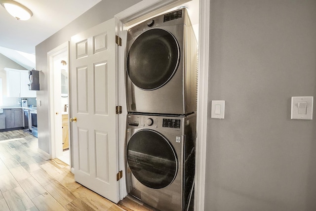 1203 Cross Bay Blvd, Broad Channel, NY 11693 - laundry room with stacked washer / drying machine and light wood-style flooring