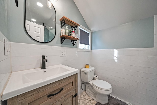 1203 Cross Bay Blvd, Broad Channel, NY 11693 - bathroom featuring tile walls, vaulted ceiling, toilet, vanity, and wainscoting