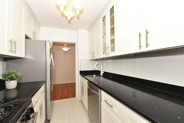 4 Birchwood Ct Unit 2K, Mineola, NY 11501 - kitchen featuring dishwasher, a sink, a chandelier, and white cabinetry