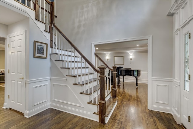 14 Rockwood Rd W, Manhasset, NY 11030 - entrance foyer with a decorative wall, dark wood finished floors, stairs, and a wainscoted wall