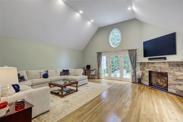 14 Rockwood Rd W, Manhasset, NY 11030 - living room with wood finished floors, high vaulted ceiling, a stone fireplace, and recessed lighting
