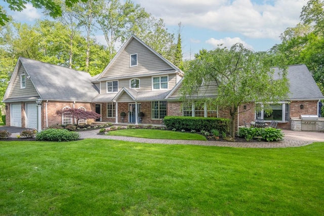 14 Rockwood Rd W, Manhasset, NY 11030 - traditional home featuring brick siding, a front yard, and driveway