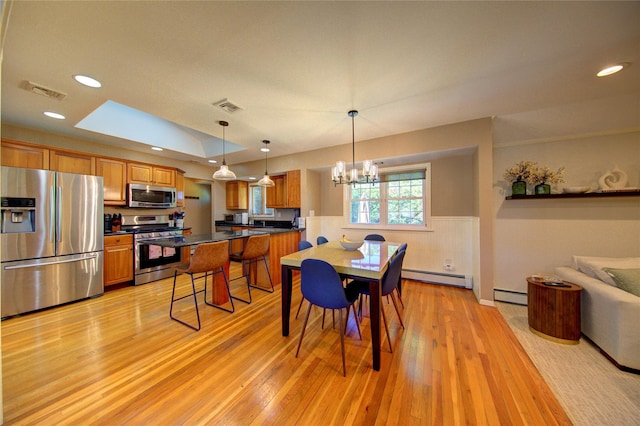 55 Richfield St, Plainview, NY 11803 - dining space featuring baseboard heating, light wood finished floors, a chandelier, a wainscoted wall, and recessed lighting