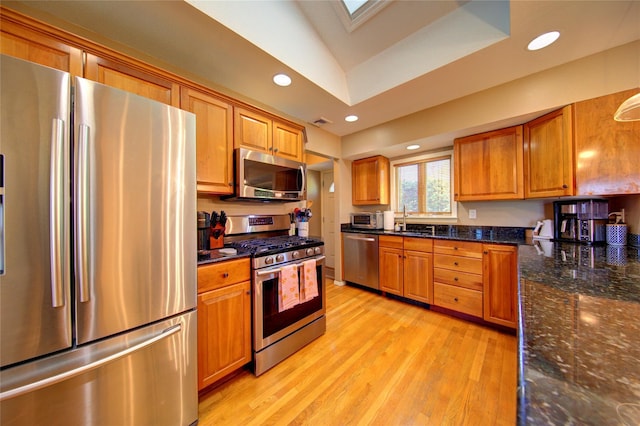 55 Richfield St, Plainview, NY 11803 - kitchen with appliances with stainless steel finishes, a sink, brown cabinetry, light wood finished floors, and recessed lighting