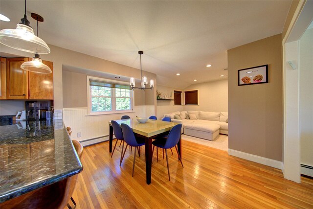 55 Richfield St, Plainview, NY 11803 - dining area featuring a baseboard radiator, wainscoting, light wood-style flooring, and a chandelier