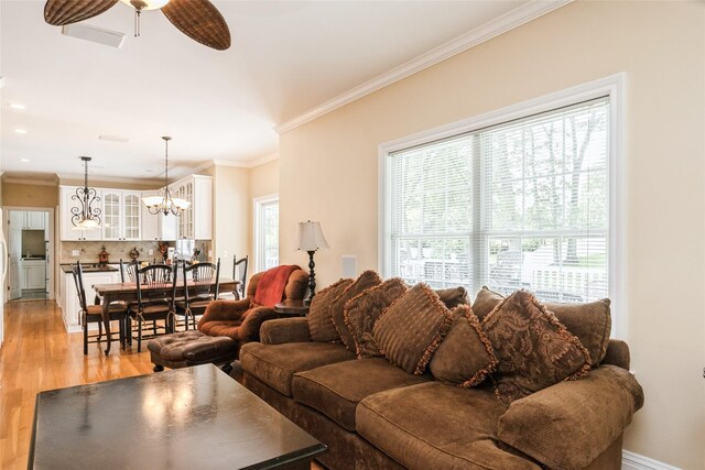 30 Lawrence Rd, Kings Park, NY 11754 - living room with light wood-type flooring, crown molding, a ceiling fan, a chandelier, and recessed lighting