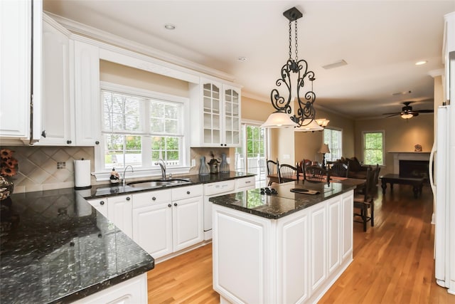 30 Lawrence Rd, Kings Park, NY 11754 - kitchen with a sink, a kitchen island, freestanding refrigerator, white cabinets, and ornamental molding