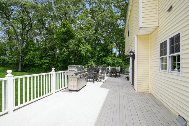 30 Lawrence Rd, Kings Park, NY 11754 - deck featuring outdoor dining space, a lawn, grilling area, and view of scattered trees