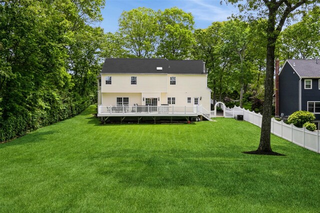 30 Lawrence Rd, Kings Park, NY 11754 - back of property featuring a deck, view of scattered trees, and central air condition unit