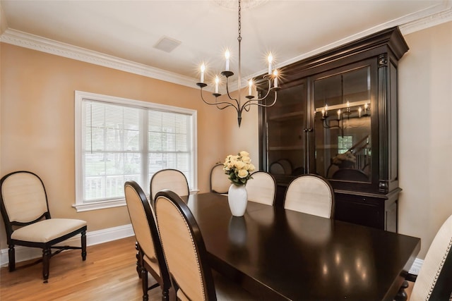 30 Lawrence Rd, Kings Park, NY 11754 - dining room with a chandelier, crown molding, light wood-style floors, and baseboards