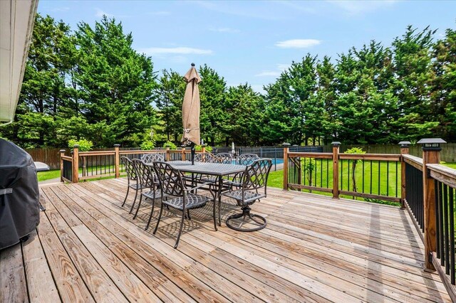 4200 Rocky Point Rd, East Marion, NY 11939 - wooden terrace featuring outdoor dining area and view of wooded area