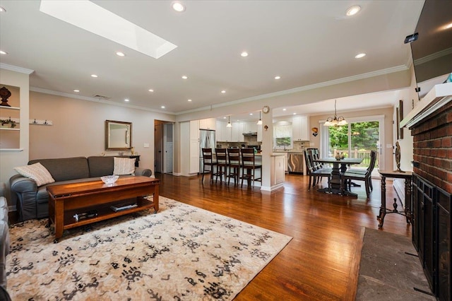 4200 Rocky Point Rd, East Marion, NY 11939 - living room with ornamental molding, dark wood-style floors, recessed lighting, a chandelier, and a skylight