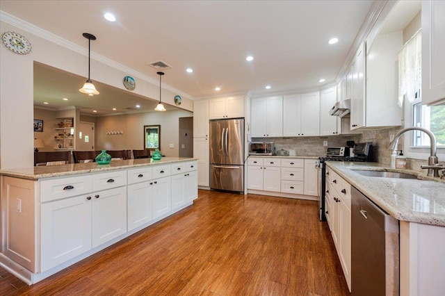 4200 Rocky Point Rd, East Marion, NY 11939 - kitchen with appliances with stainless steel finishes, a sink, wood finished floors, a center island, and crown molding