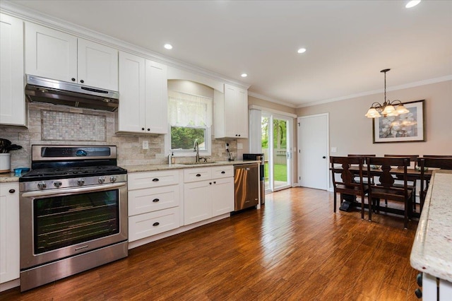 4200 Rocky Point Rd, East Marion, NY 11939 - kitchen featuring appliances with stainless steel finishes, under cabinet range hood, a sink, crown molding, and a chandelier