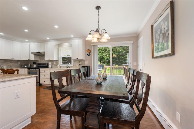4200 Rocky Point Rd, East Marion, NY 11939 - dining room featuring baseboard heating, crown molding, a chandelier, dark wood-type flooring, and baseboards