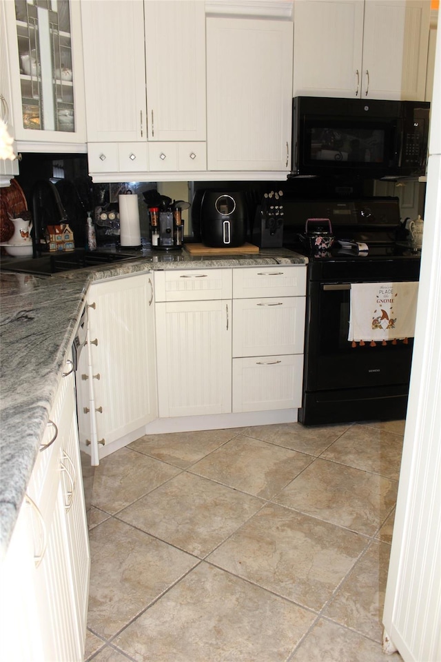 1 Rose Ct, East Islip, NY 11730 - kitchen featuring black appliances, decorative backsplash, light stone countertops, and white cabinets
